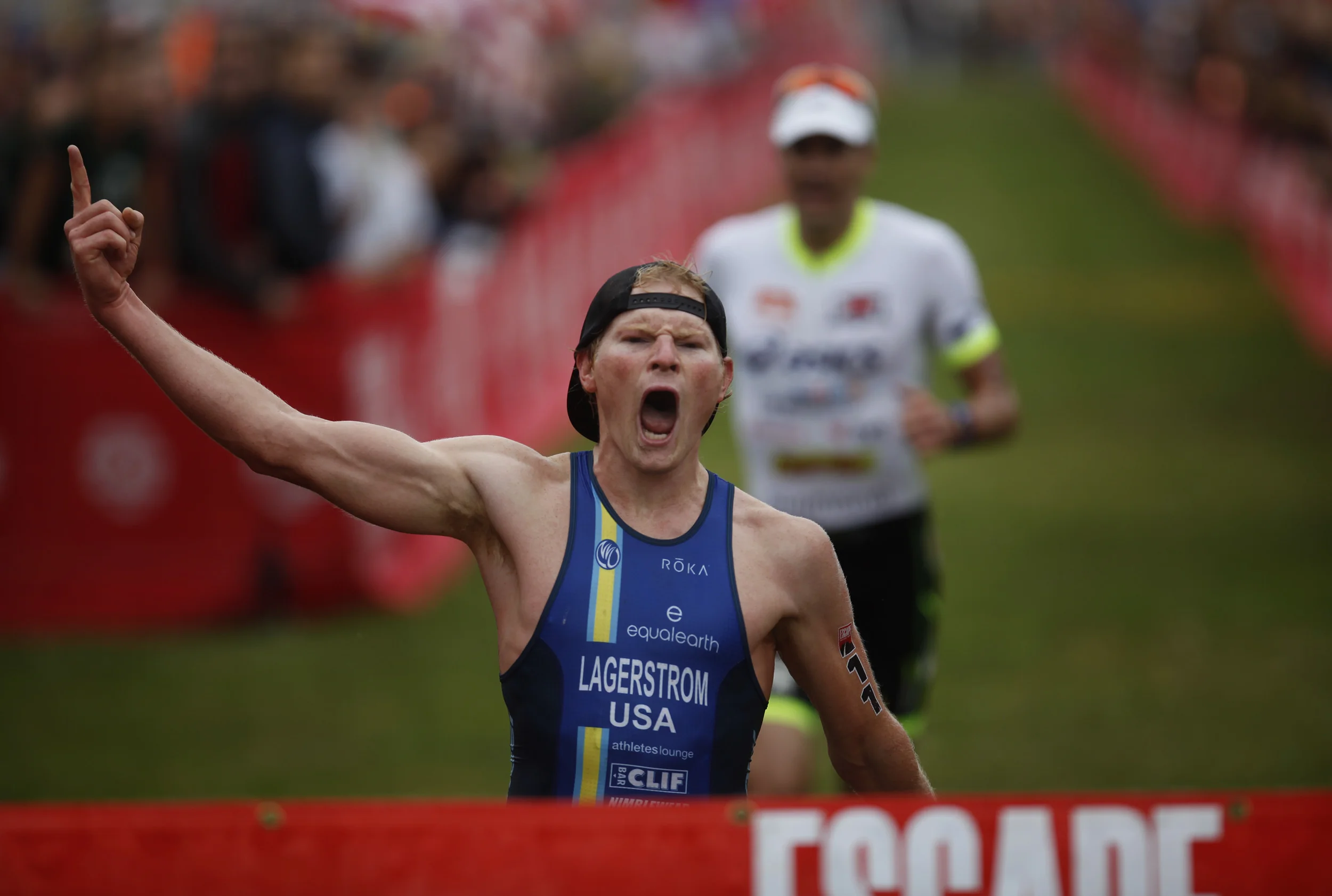   Eric Lagerstrom, from Portland, Oregon (left), passes Andy Potts, from Colorado Springs (right), to clinch first place by two seconds in the "Escape from Alcatraz" triathlon in San Francisco, California, on Sunday, June 7, 2015  