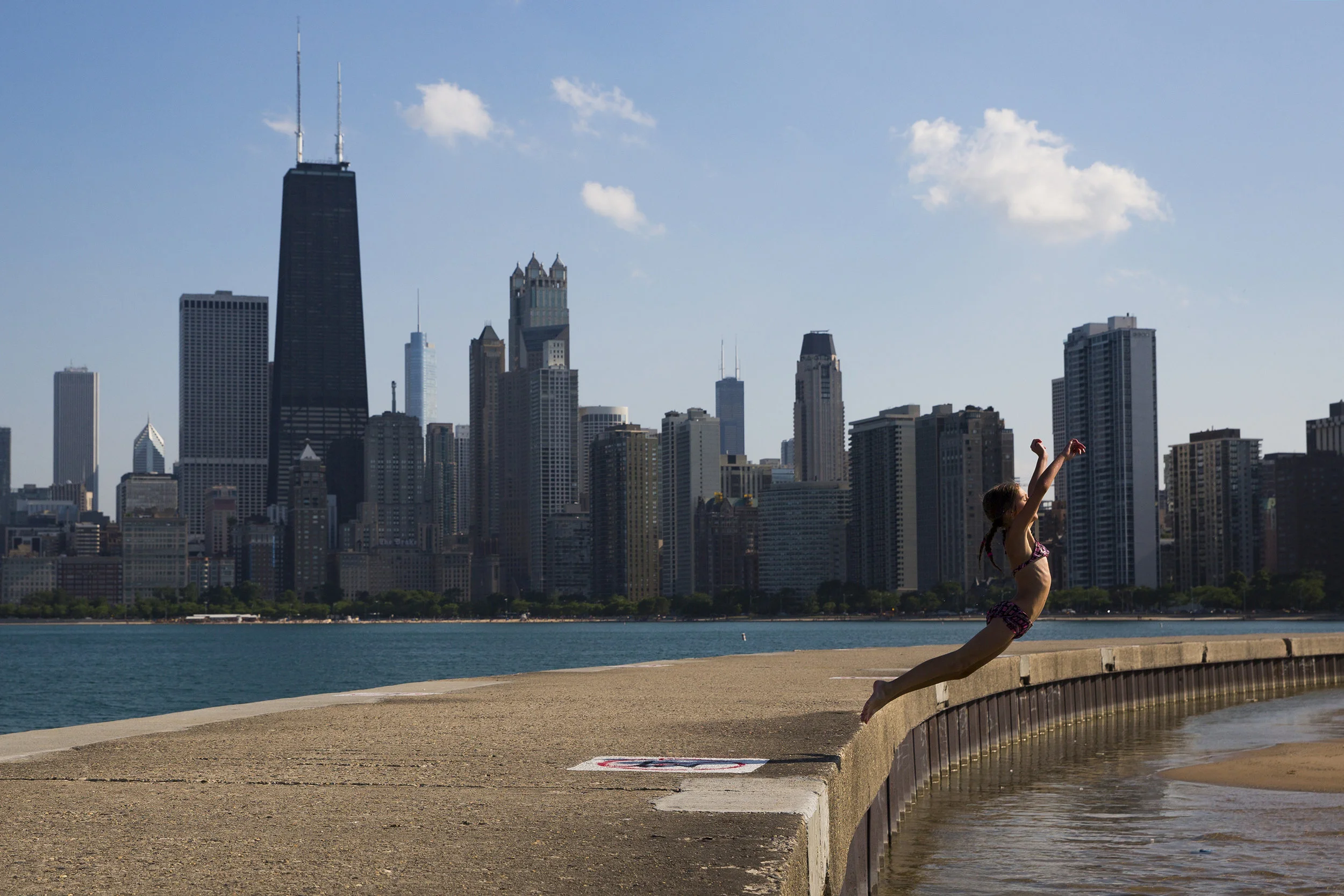  Giana Murray jumps into the water at North Avenue Beach on Monday, June 20, 2016 in Chicago. 