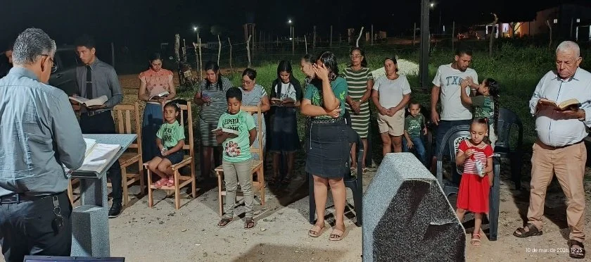 Church service in the yard of people’s homes while church is being built