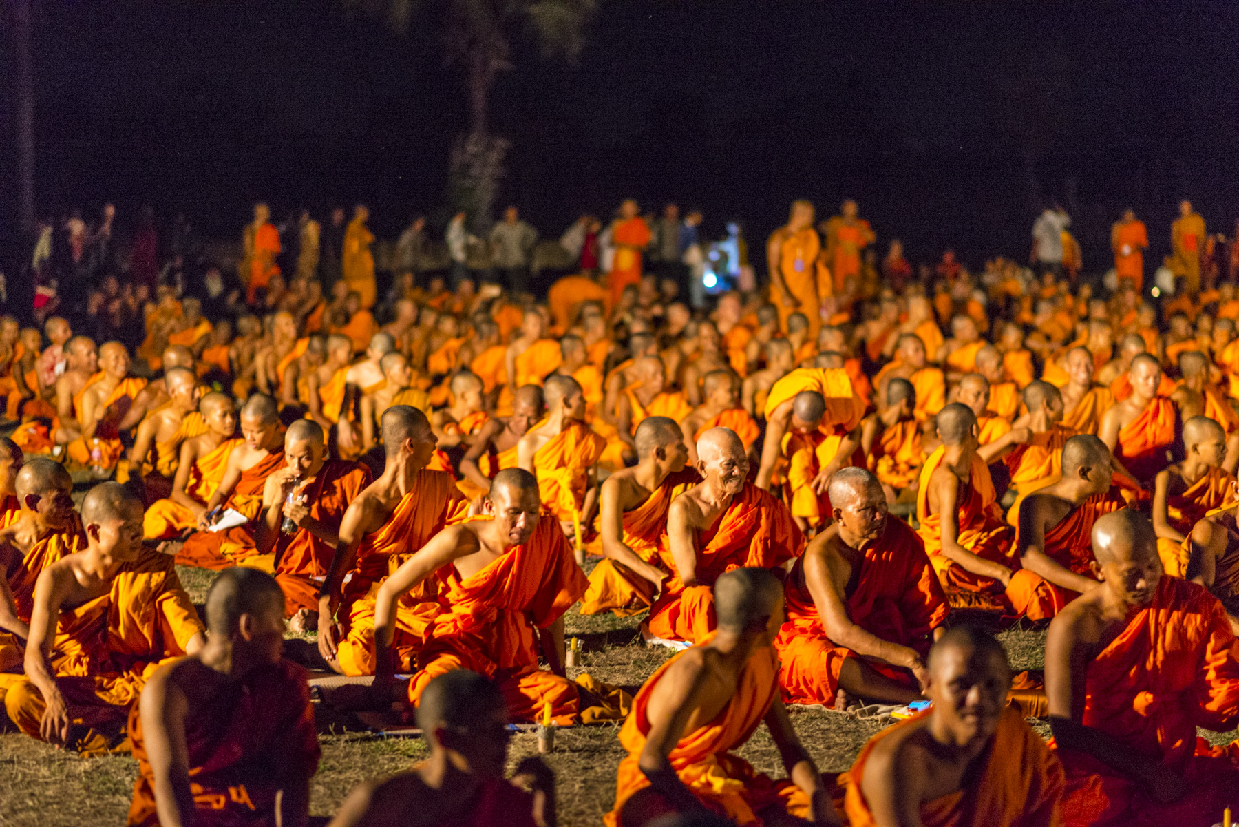 Monks resting in the grass before they enter the temple for meditation. As part of traditional culture, every Cambodian spends a year of their childhood as a monk or nun to learn the Buddhist way of life.
