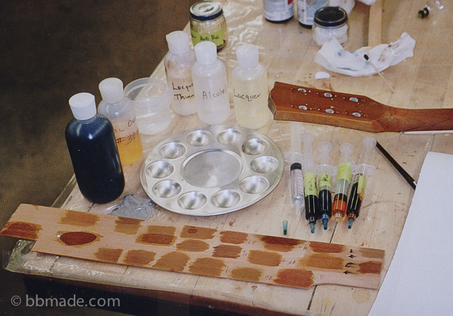 Here is a Gibson Les Paul that suffered several headstock breaks. I re-attached the headstock, patched in new wood to reenforce it and was working on color matching using the same piece of wood I used to reenforce the broken area.