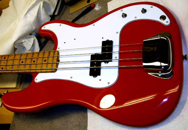 Here I have refinished the P-bass ONLY because the owner had stripped the original finish. The circle you see in the picture is the bench light reflecting off the nitrocellulose gloss lacquer. After a few more parts were put back in place, this bass was ready to face another sixty years.