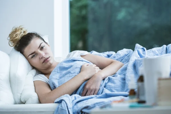 bigstock-Sick-Woman-Lying-In-Bed-102759704.jpg