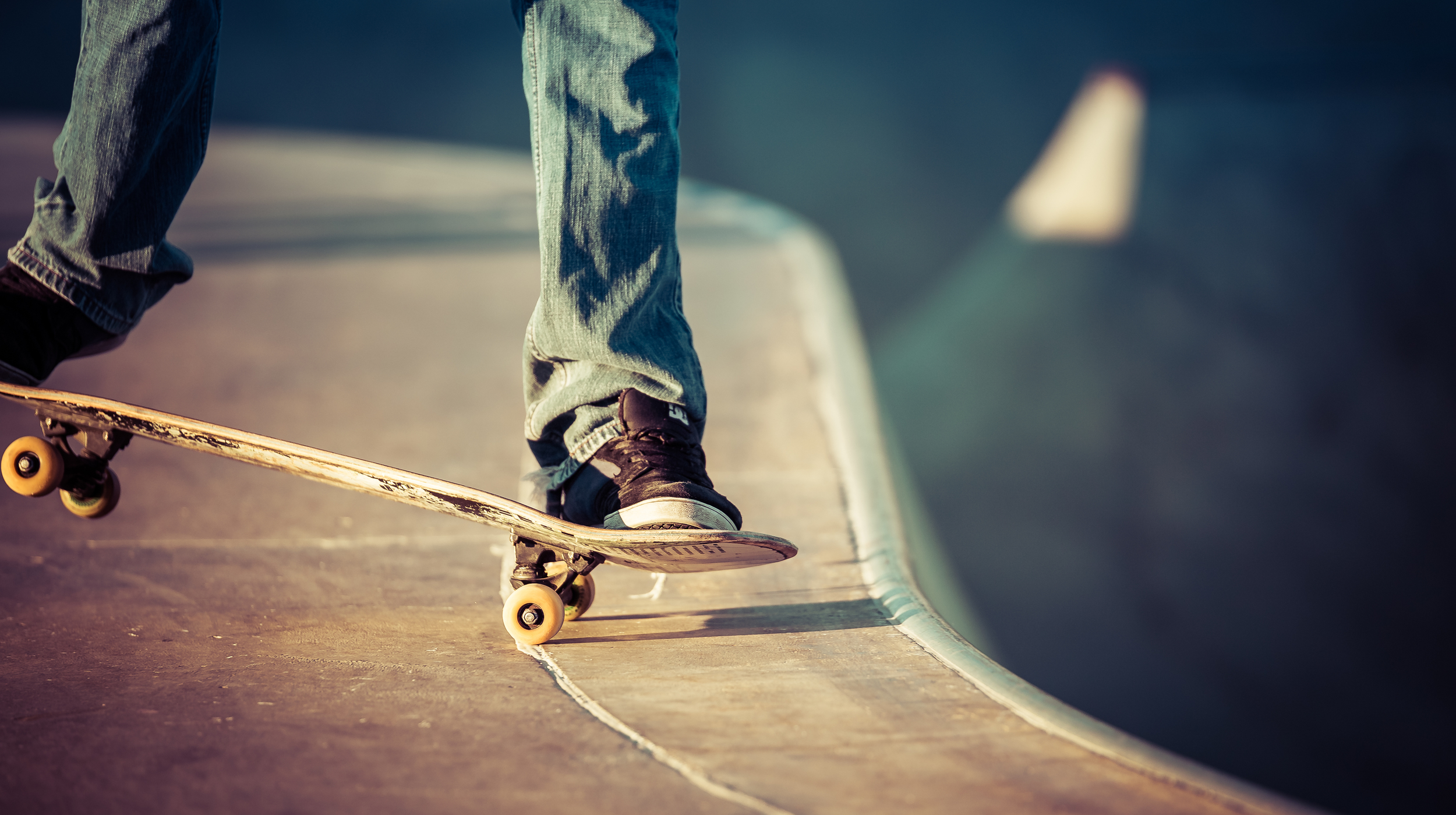 A skater performs a nose manual before dropping in
