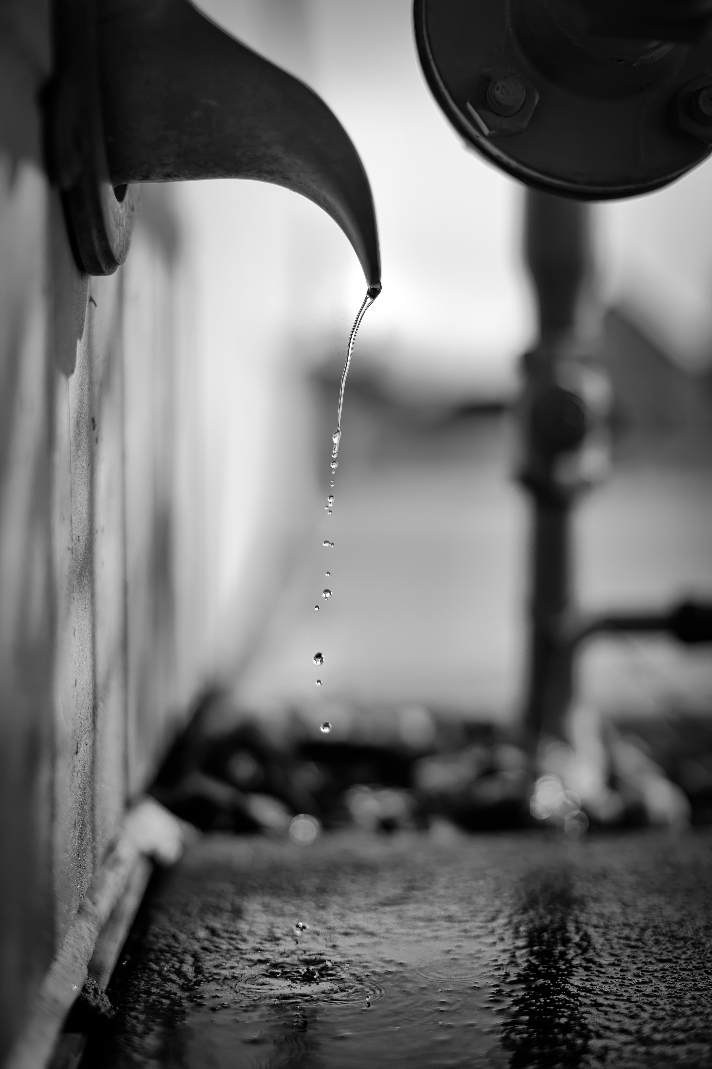 Water drips from the snow melt from the drain. Its the beauty in the little things that we miss in our daily lives.