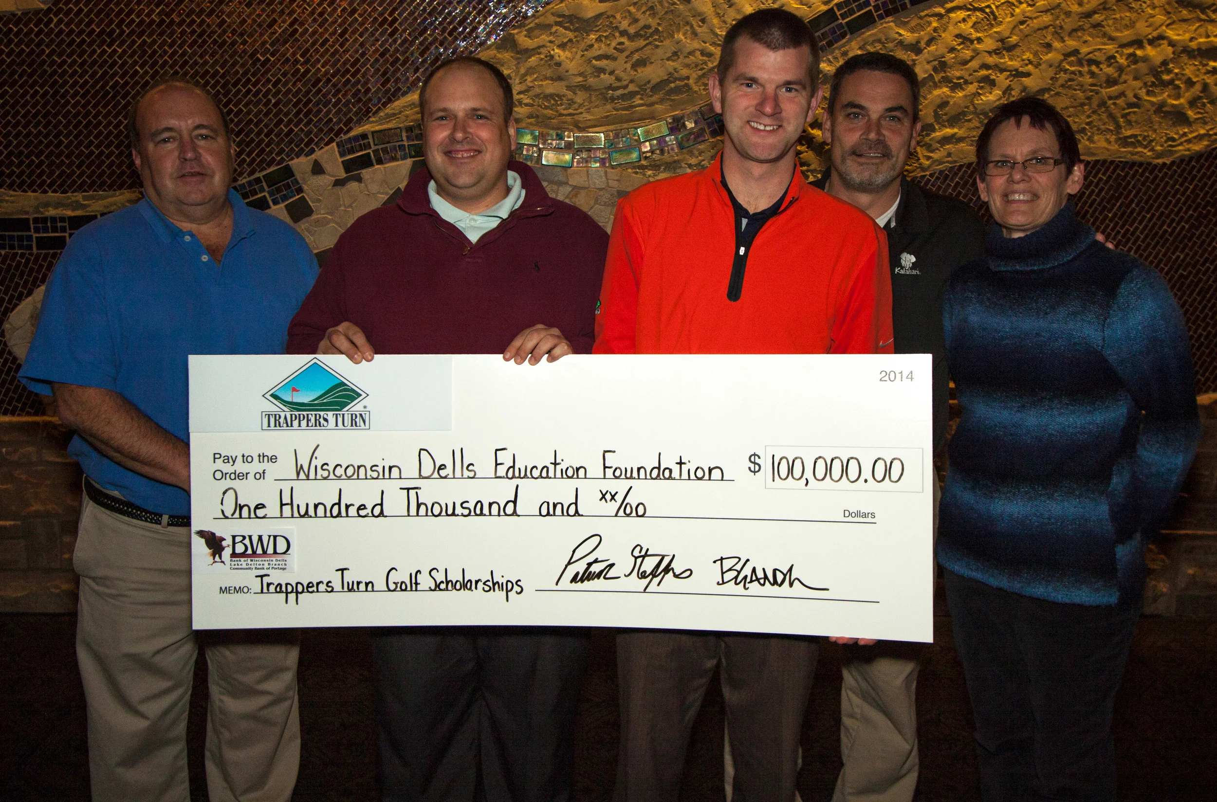 Representing Trappers Turn Golf Club in Wisconsin Dells are Patrick Steffes and Bob Gander presenting a $100,000 check to the Wisconsin Dells Education Foundation. This donation will establish endowment funds for the Girls and Boys Golf Scholarships at Wisconsin Dells High School. A $2,000 scholarship will be award each year to a senior girl and boy on the golf teams. Accepting the donation for the Foundation are board members: Joe Gussel, Todd Nelson, and Marti Fults.