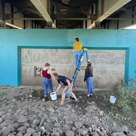  Students from the University of Wyoming’s Printmaking classes help to install the work.  