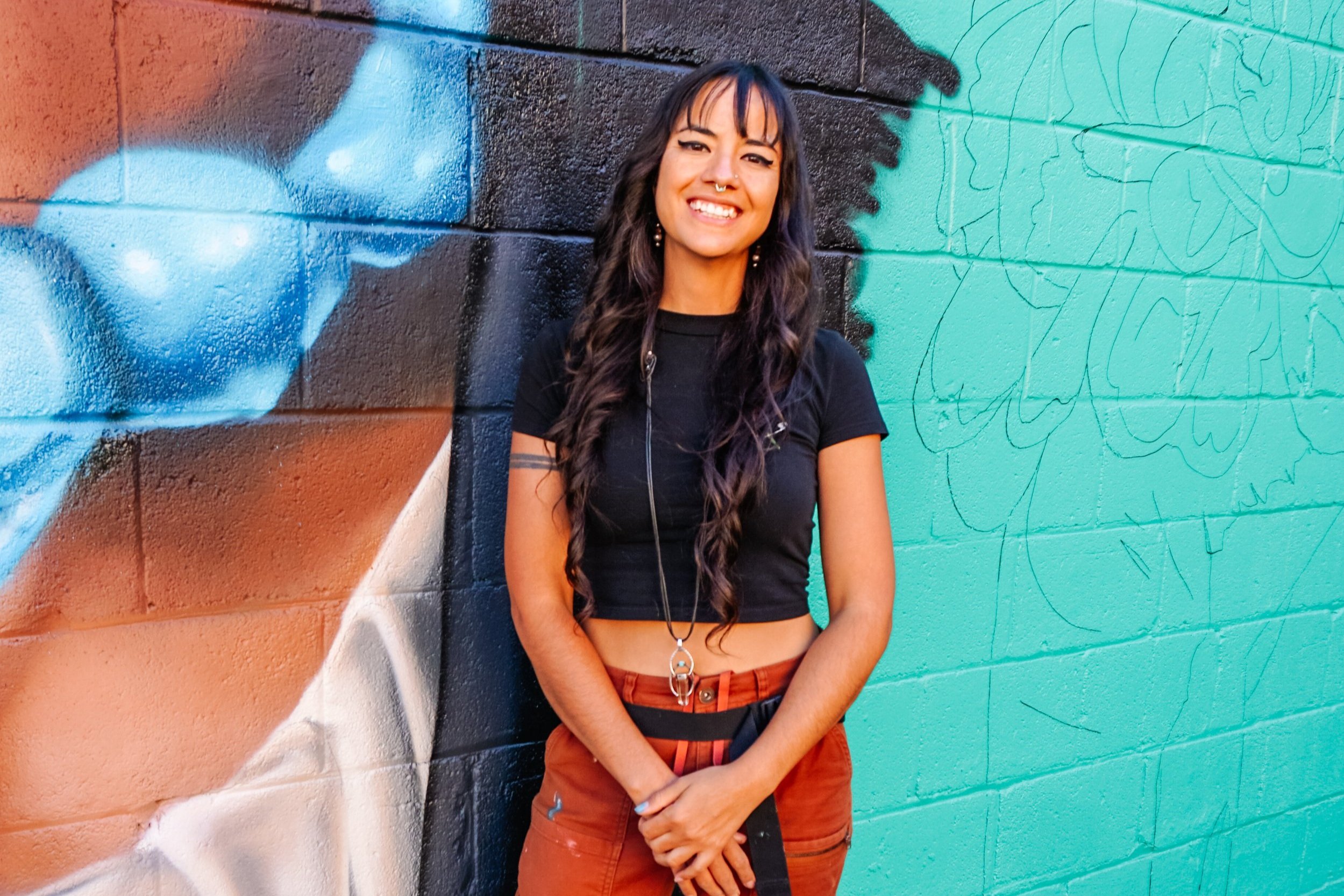  The artist, Jodie Herrera, with the in-process work. Image by Luna Photography. 