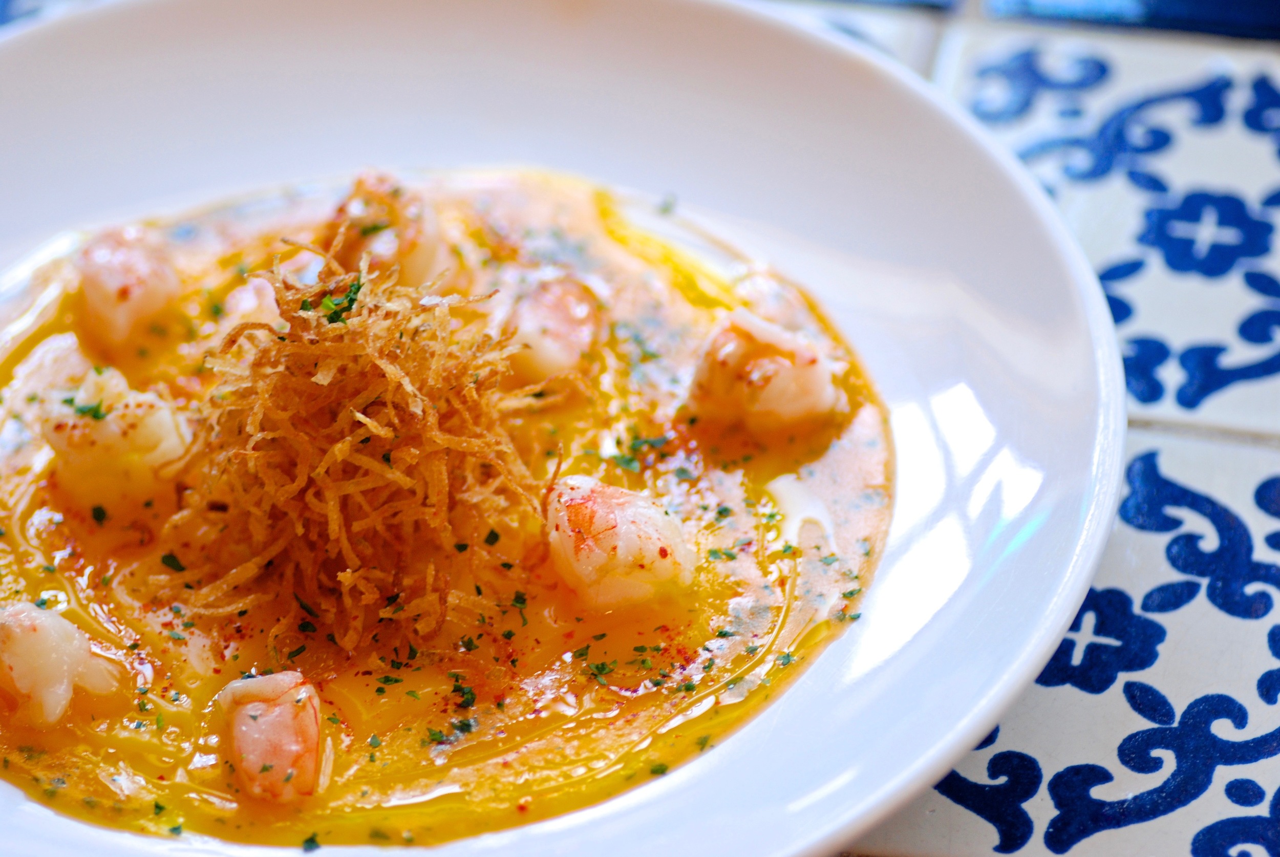 Poached Langoustine. Egg Yolk Carpaccio. Matchstick Potato. Crustacean Butter.