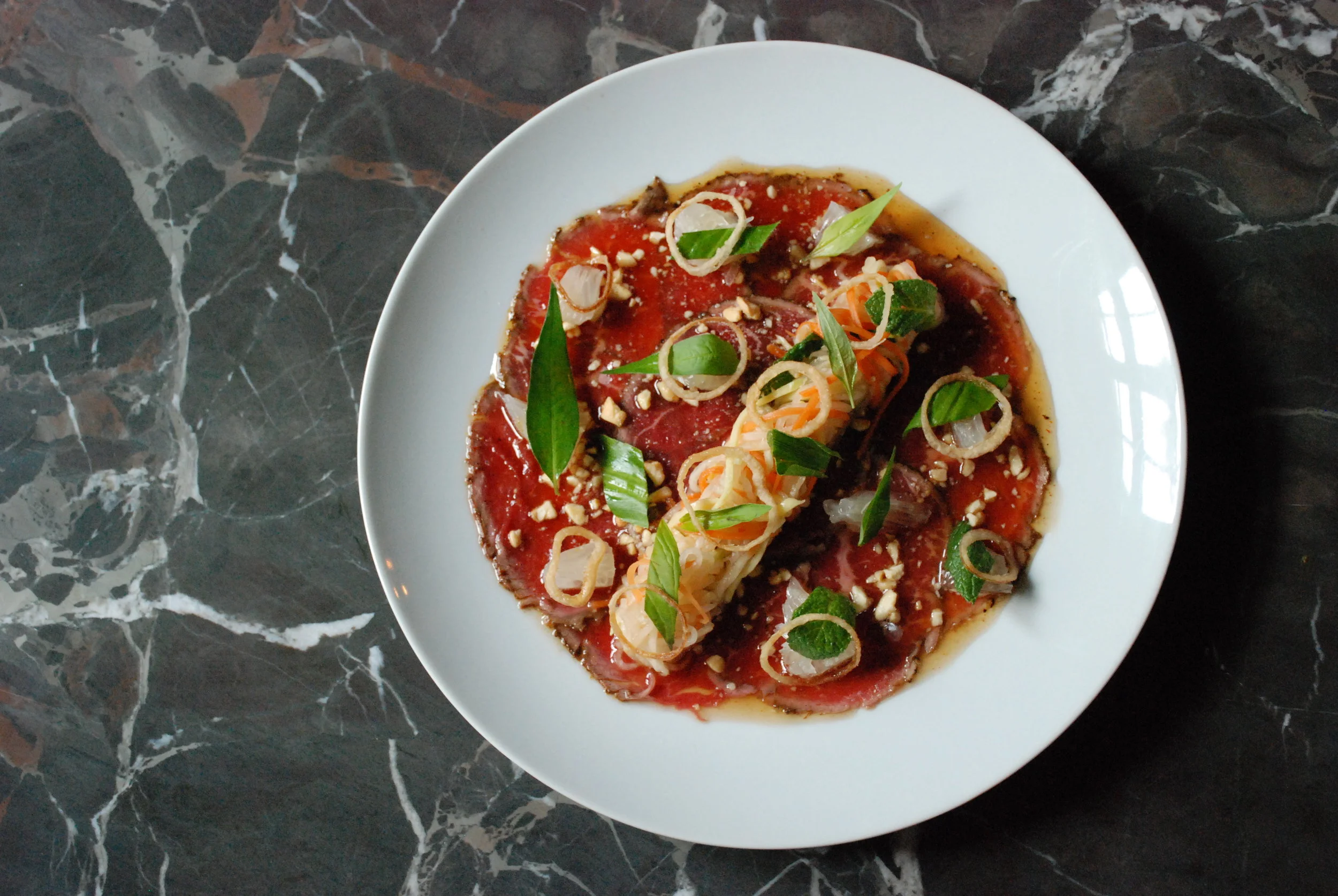  Beef Carpaccio. Green Mango. Pomelo. Shallot. Herbs. Nuoc Cham. 