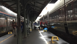 Amtrak southbound Coast Starlight and northbound Cascades trains meet at Portland, OR Union Station (with Red Cap assisting passengers)