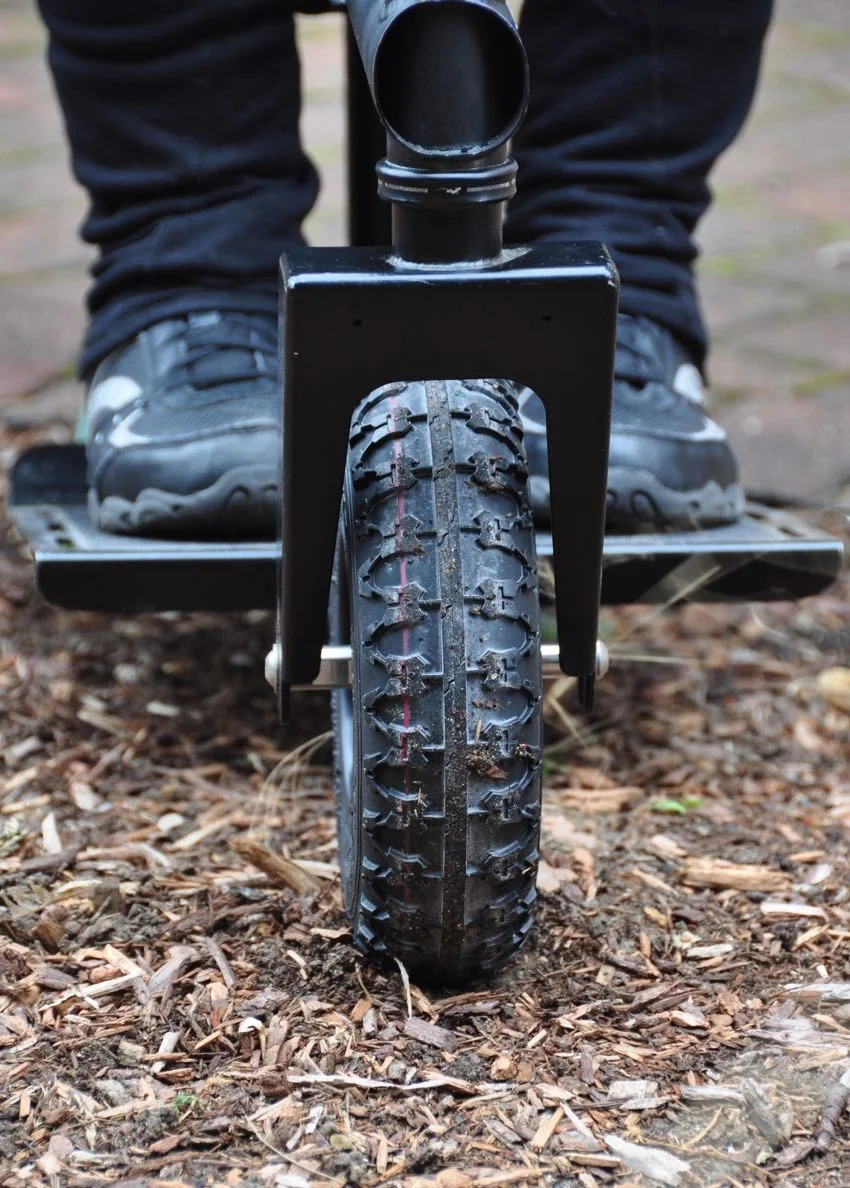 The ridge down the center of the wheel helps on pavement. The width of the wheel helps on soft ground.