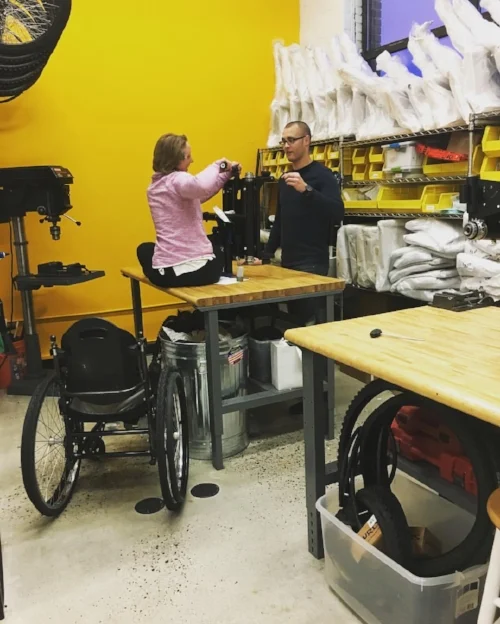 While Ben was teaching me to assemble the intricate parts of the Freedom Chair, I couldn't reach, so I hopped up on the work table!