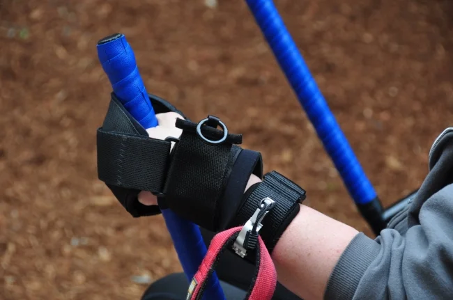 Utilizing the Liberty Wristband in conjunction with the Active Hands grip aids on the levers of the GRIT Freedom Chair.