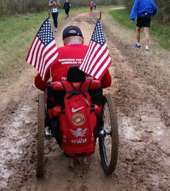 Bennie Jose Perez tackles a muddy trail to complete the Brazos Bend 100 Marathon in his GRIT Freedom Chair.