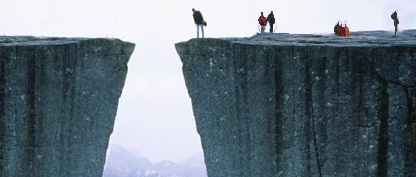 Photo of a person looking down on a cliff