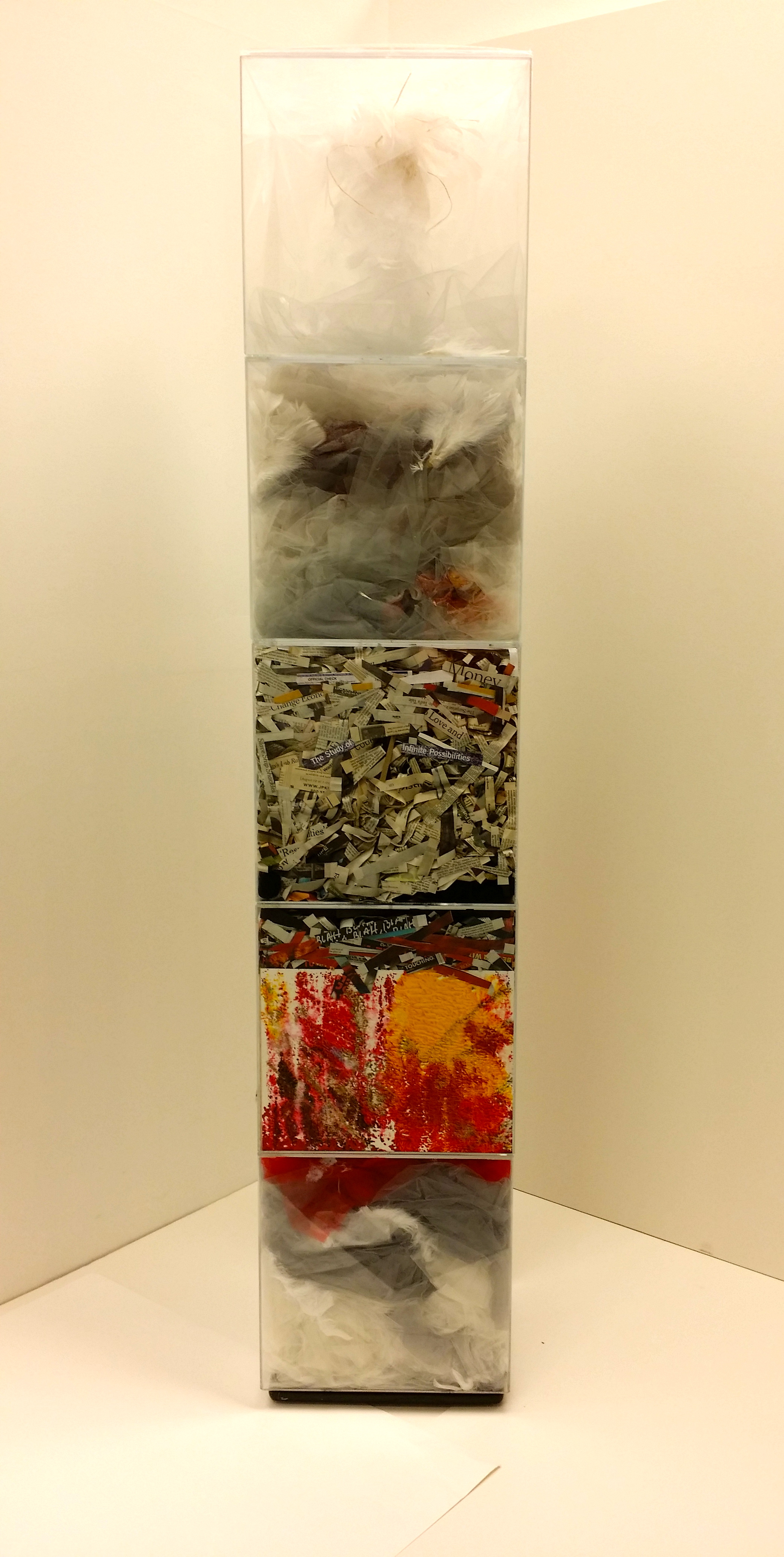  An Hypothesis, 2015 Installation 12 x 12&nbsp;x 62 inches  Five acrylic cubes containing dyed gray&nbsp;gauze, lightweight tulle, feathers,&nbsp;newspaper clippings, textured acrylic&nbsp;drawings, and dripped paint, arranged in&nbsp;the boxes so as