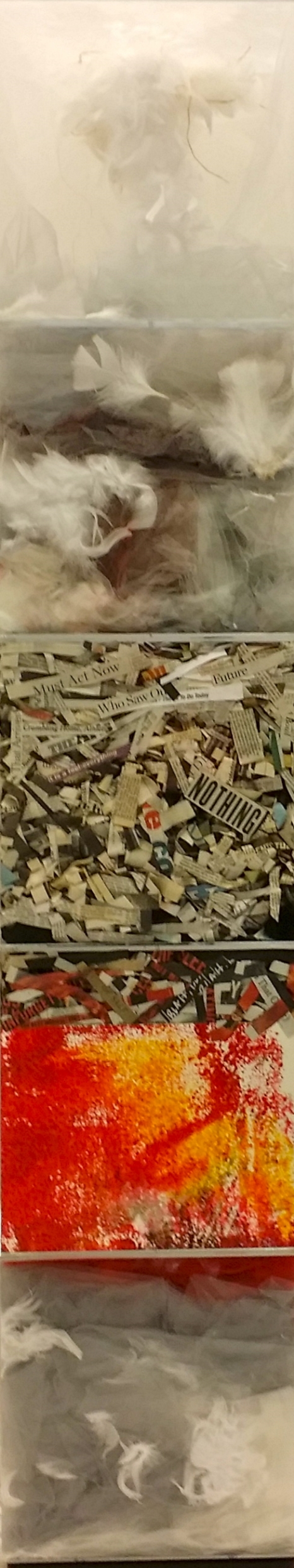 An Hypothesis, 2015, Installation 84 x 12 x 12 inches Five acrylic cubes containing dyed gray gauze, lightweight tulle, feathers, newspaper clippings, textured acrylic drawings, and dripped paint, arranged in the boxes so as to fill and modify their space. Each cube defines a separate space, yet the content of each bleeds into the next, connecting them into the whole. While the contents can be seen as unrelated, they can also be perceived as one in essence. The stacked boxes suggest an orderly sequence, hinting at a logical cycle in which the materials are arranged.