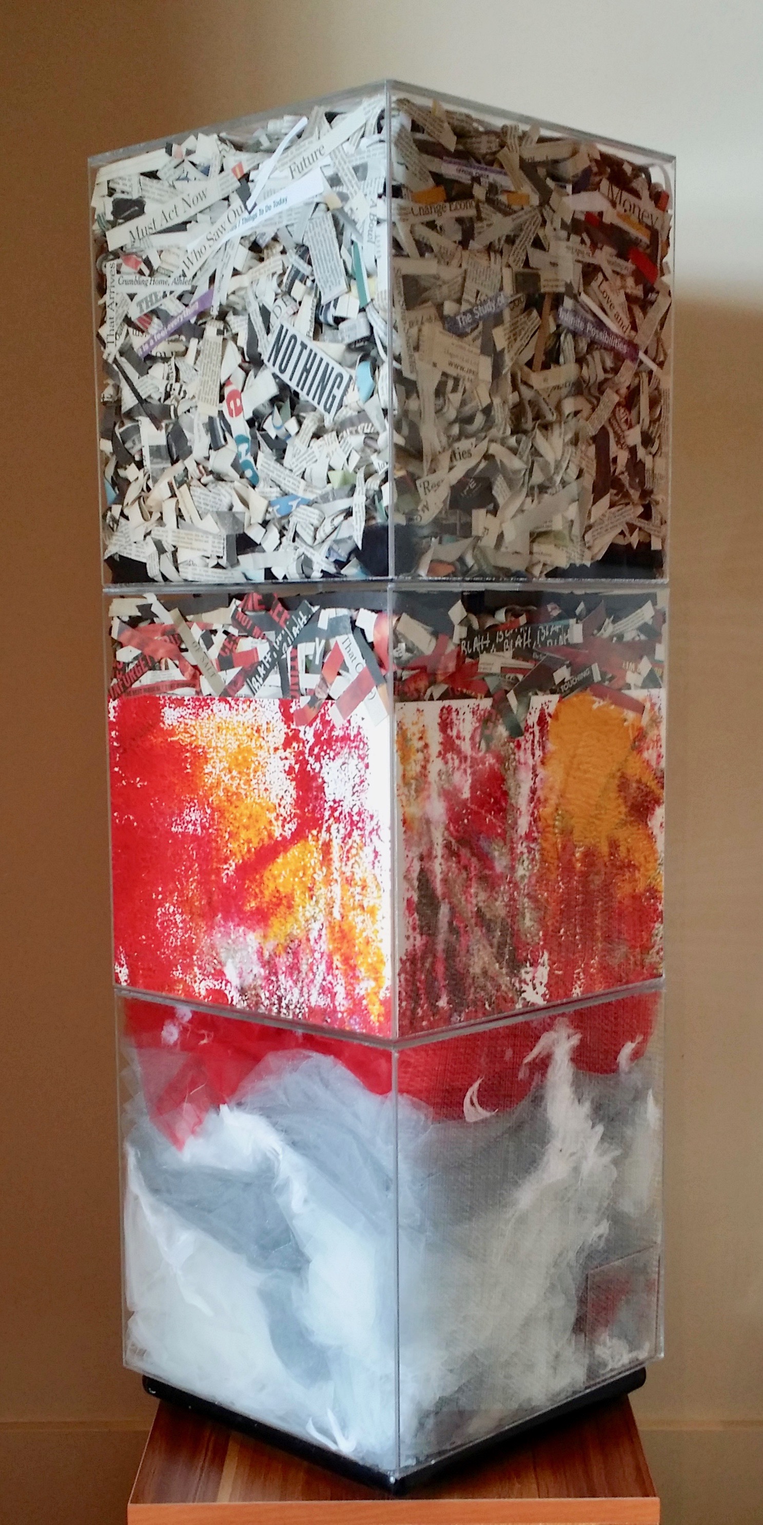  An Hypothesis, 2015 Installation 38 x 12.5 x 12.5 inches  Three acrylic cubes containing newspaper clippings, paintings, fabric 