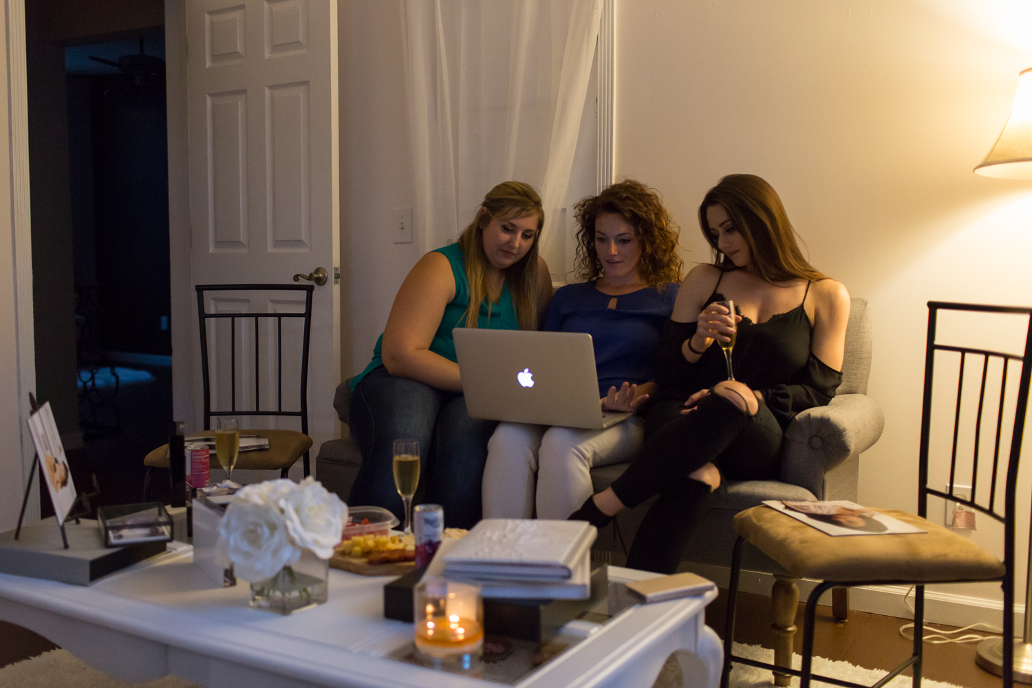 3 Women sitting on a couch looking at a computer