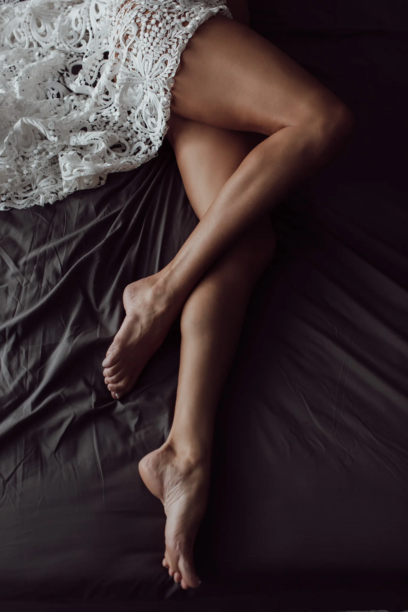 legs with white lace, bed posing. Sebastian, florida. 