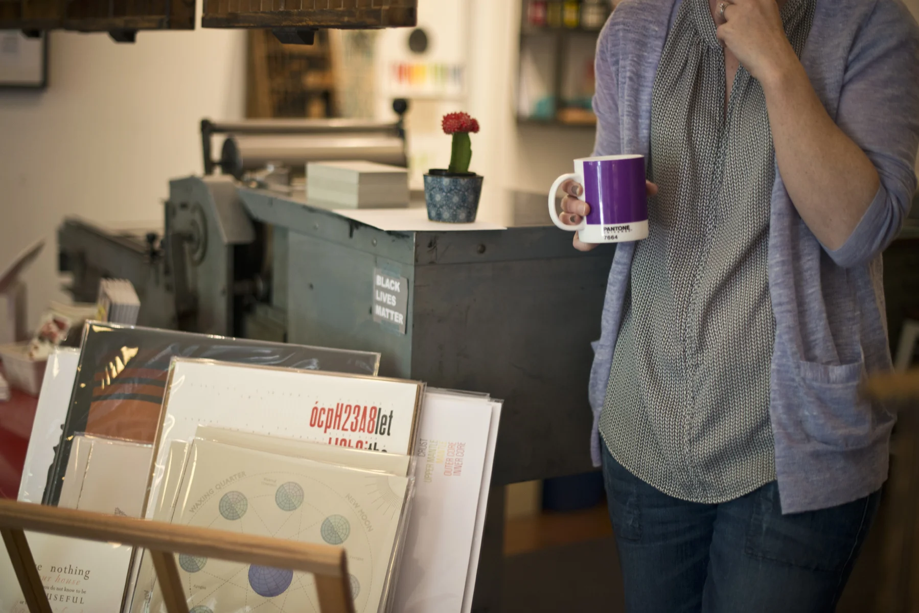 Mandolin Brassaw, owner of Grapheme, with Pantone tea and her letterpress.