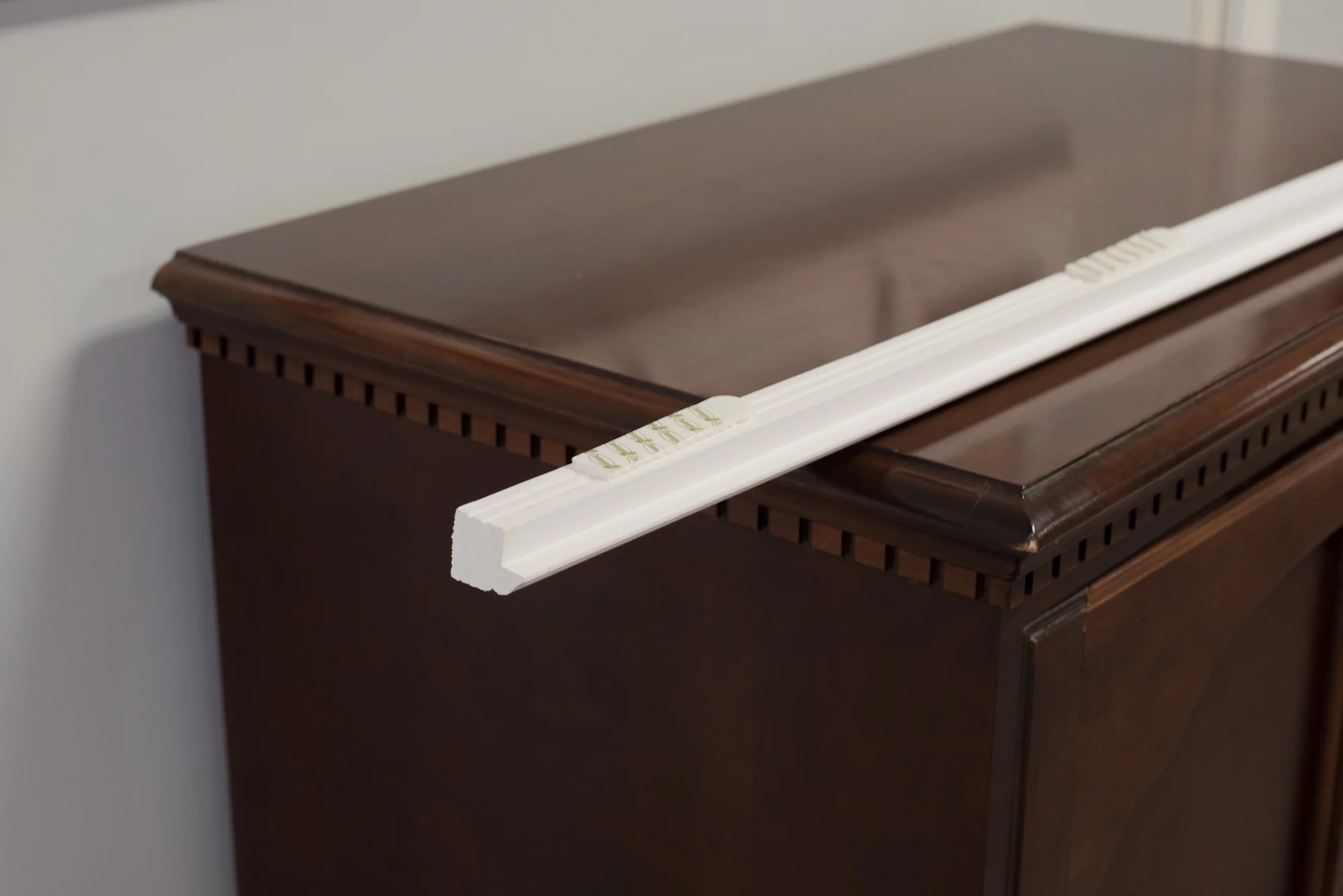 The molding I selected for my reveal shelves. Four pairs of the velcro are situated along the length of the molding.
