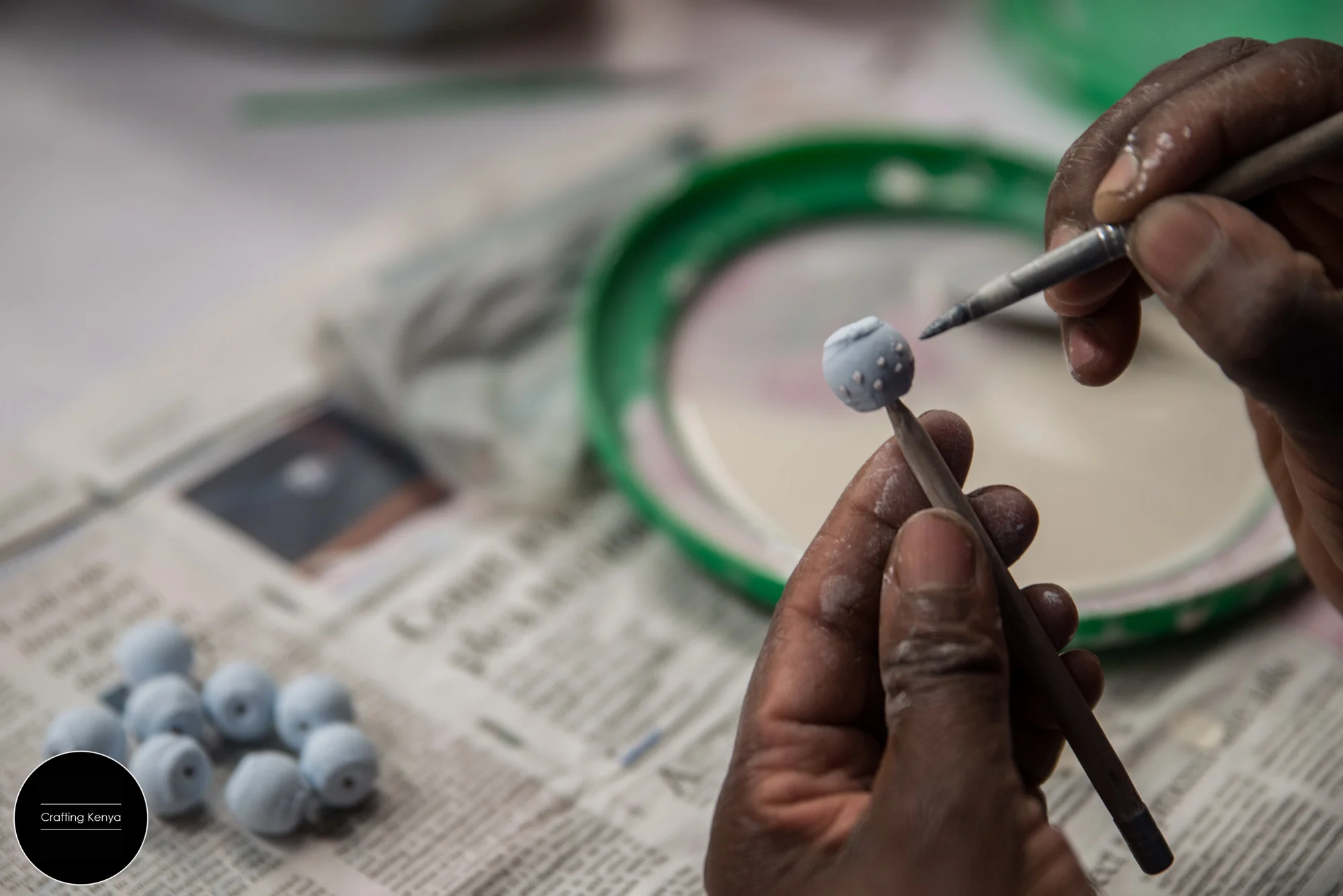 Glazing ceramic beads before putting them in the kiln. Kazuri Beads