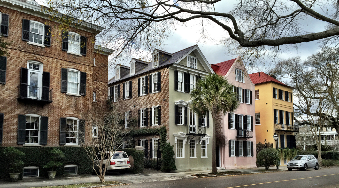 The green and pink house could be considered sister houses. Notice that each building is different, but each has white windows...the glue.