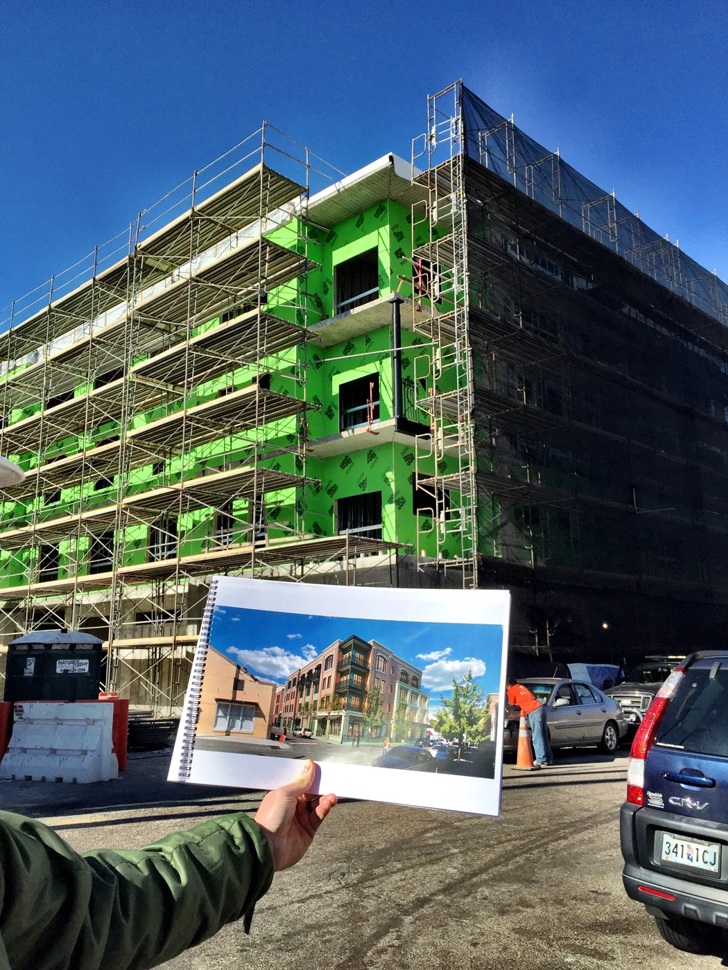 That green stuff is gypsum sheathing. You can see that there is a mockup of one of the steel columns on the corner balcony.