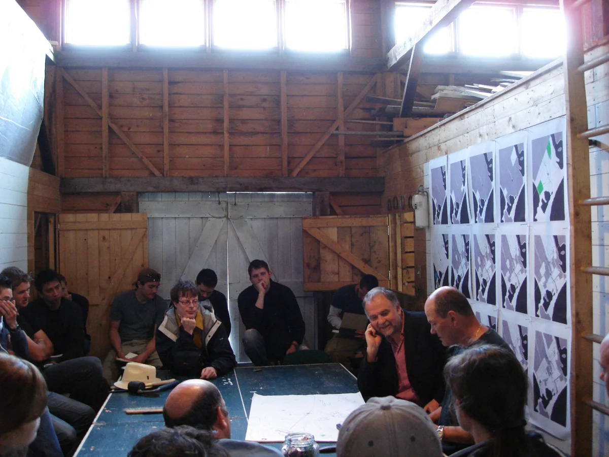 A ping pong table was used as the main work surface. On the far right is the architectural writer Peter Buchanan and Brian MacKay-Lyons. 