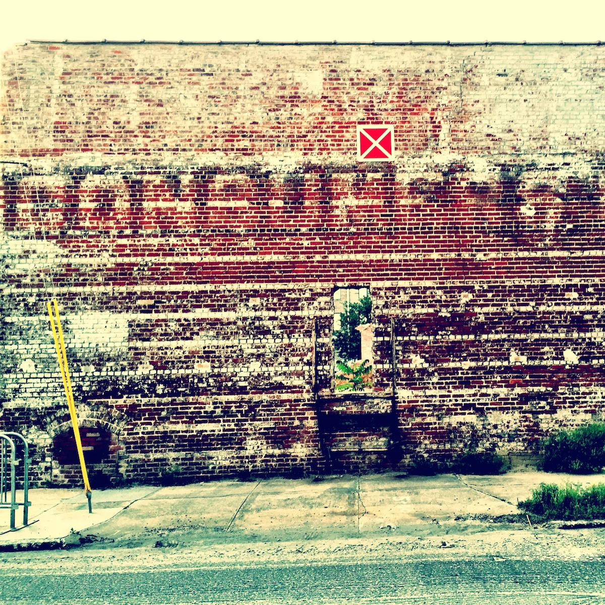 You will be seeing more of this wall in the future. I am working on a housing development on this site and this old wall will be incorporated into the design. The ghost sign says 'CONSUMERS', and on the part that I cropped on the right side it says 'ICE CO'. 
