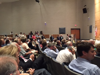 In the background you can see the line of public ready to comment.