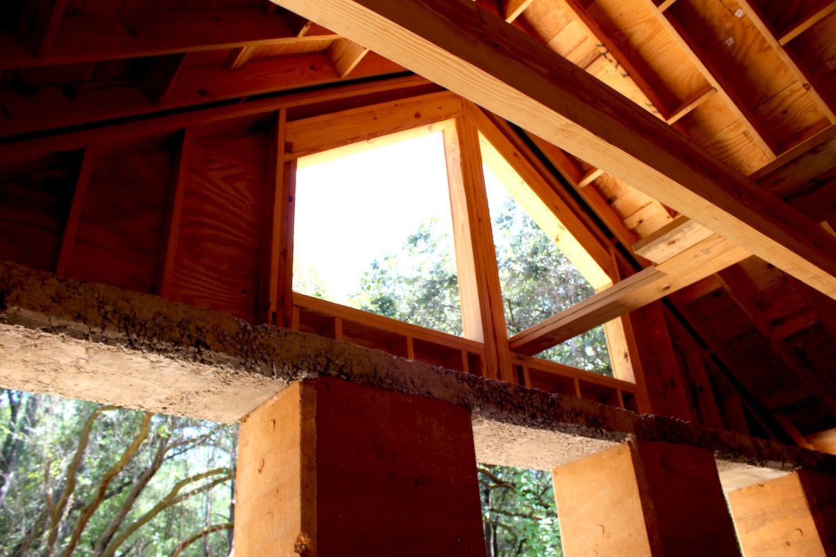Interior view of the Walters Residence. One thing to point out is that the rammed earth is the structure of the wall and will also be the finish on both the exterior side and the interior. Traditional wood framing was used above the window headers. Photo Credit: Danielle Ramos