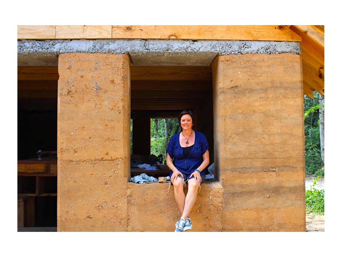 Architect April Magill of Root Down Designs. Sitting in the window sill of Charleston's first Rammed Earth House: The Walters Residence. Photo Credit: Danielle Ramos