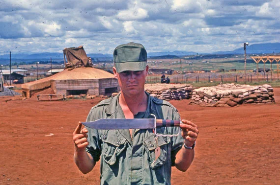 Jeff in combat holding a captured weapon.