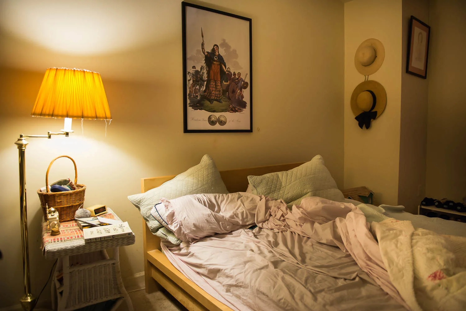 The bed sits unmade in the early morning hours in Joani Peacock’s bedroom at her Alexandria, Va., home, Saturday, Oct. 4, 2014. Peacock says that she strives to live a balanced life with bipolar disorder and surrounds herself with objects she has collected, including an image of Celtic war queen Boudicea that hangs over her bed.