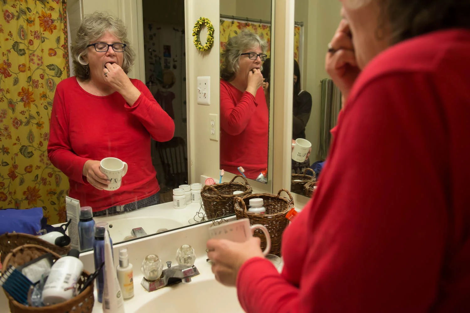 Joani Peacock takes a pill prescribed to treat her bipolar disorder at her home in Alexandria, Va., Friday, Oct. 3, 2014. Peacock, who was diagnosed with bipolar disorder 10 years ago, now takes three medications each evening before going to bed to help maintain balanced mood and energy.