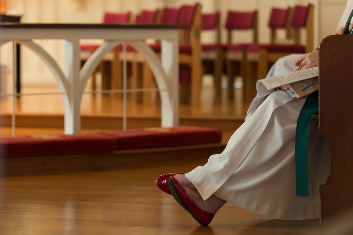 Episcopal priest Joani Peacock sits near the altar during a service she is leading at Emmanuel Episcopal Church in Alexandria, Va., Sunday, Sept. 28, 2014. Peacock, who has bipolar disorder, speaks publicly about her experience and recently led a discussion group about mental illness at the church.