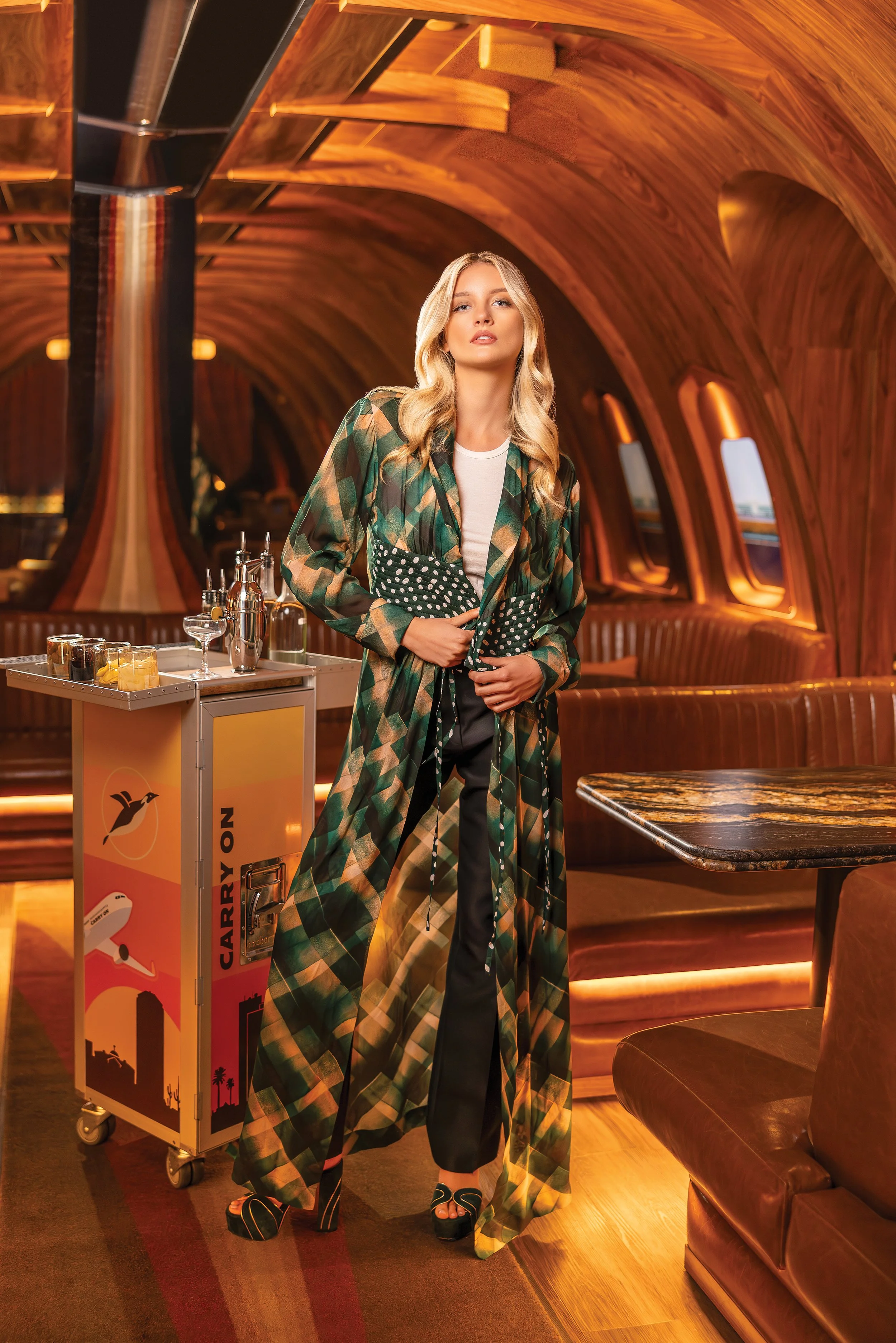   JACKET:  Multicolor long-sleeved maxi, DrieVan Noten, $1,695.  TOP:  Cream tank, Eterne, $75.  PANTS:  Black pleated trousers, The Row, $1,250.  SHOES:  Hunter and gold chunky heel, Gianvito Rossi, $1,495. All from Wunderkind,  shopwunderkind.com  