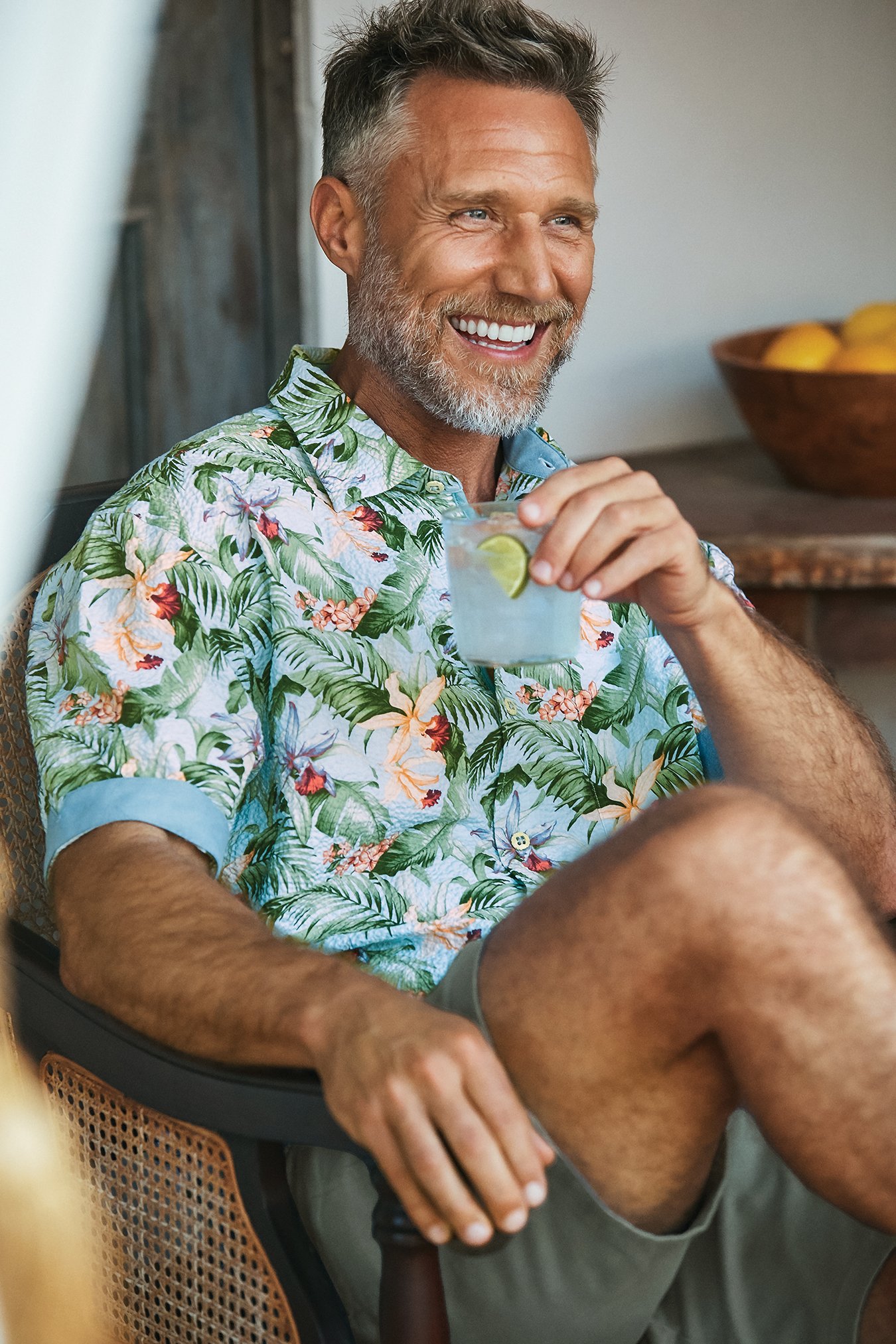  SHIRT:  Tropical print short-sleeved button-down, $135.  SHORTS:  Gray, $115. Both from Tommy Bahama,  www.tommybahma.com . 
