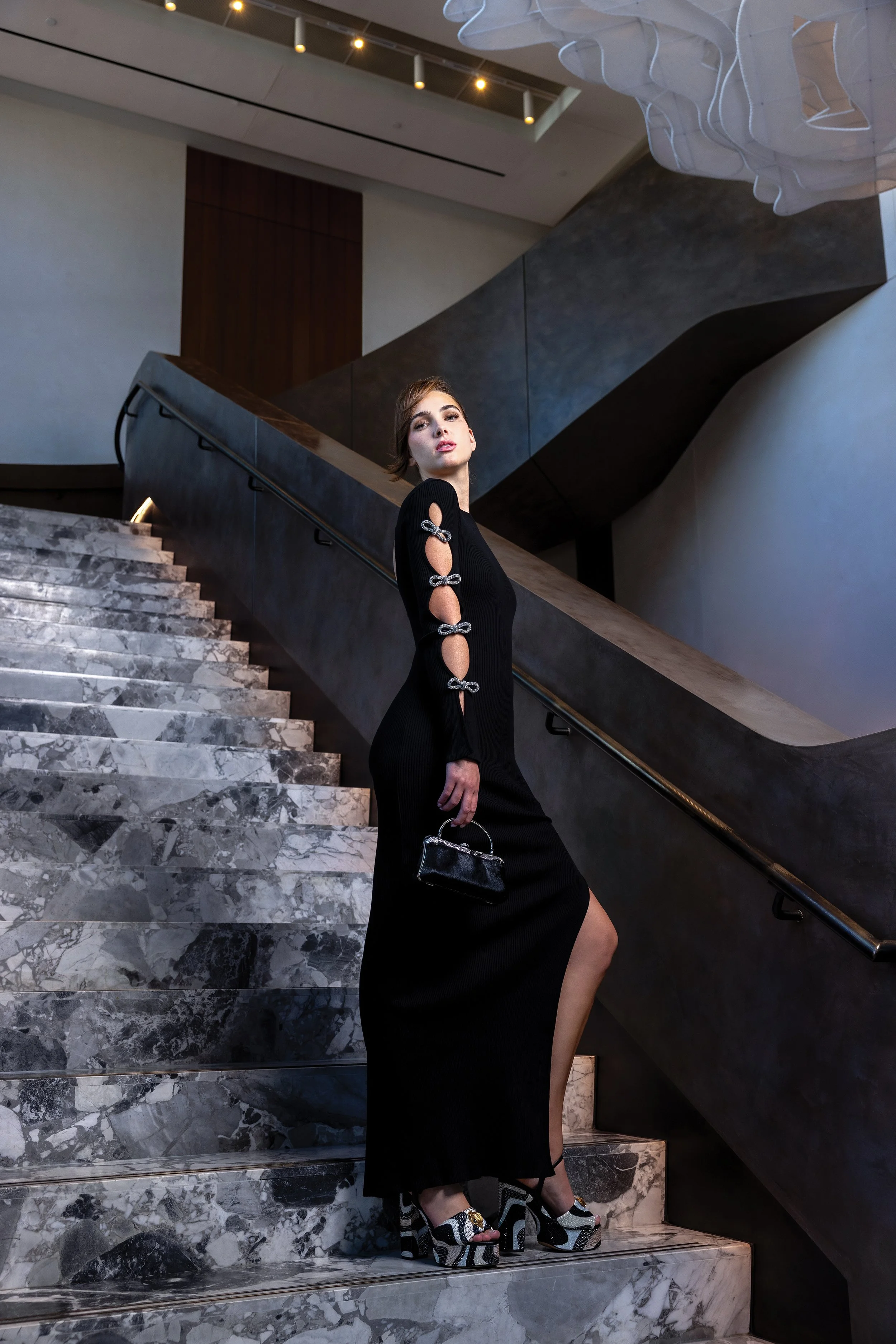   DRESS:  Black long-sleeved knit cutout bow maxi, Mach &amp; Mach, $395.  HANDBAG:  Black-and-white mohair clutch, Isabella Adams, $59.95.&nbsp;  SHOES:  Black-and-white embellished platforms, Kurt Geiger, $79.95. All from My Sister’s Closet,  www.m