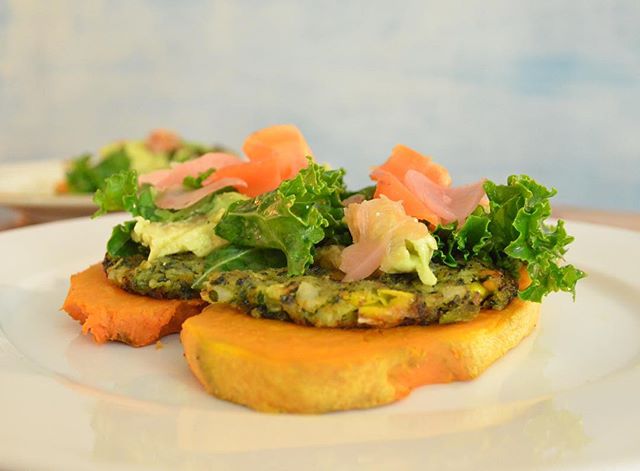 breakfast is one of my all-time favorite meals. prep ahead by baking sliced sweet potatoes for quick morning meal. from the top: kimchi, kale drenched in lemon, olive oil and sea salt, avocado, dr. praegers kale burger all on top of a sweet potato to