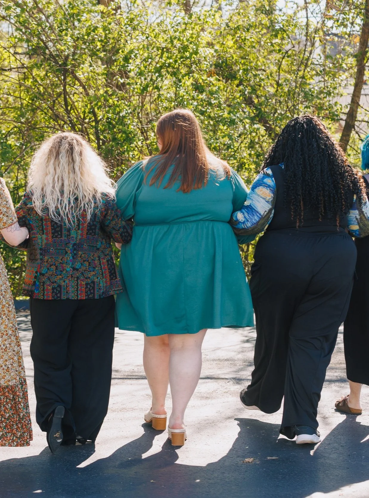 group walking arm in arm