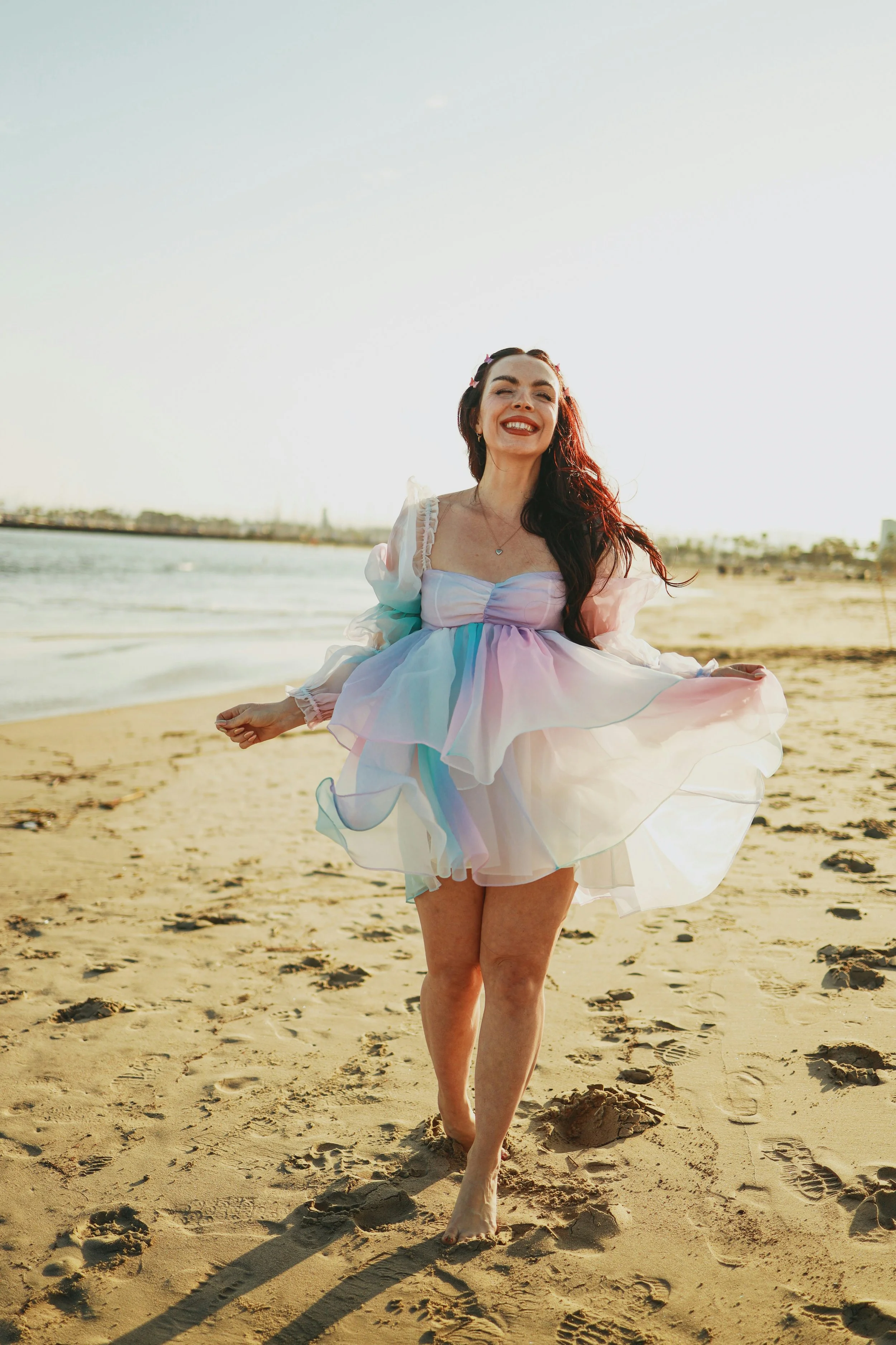 woman in whimsical dress on the beach