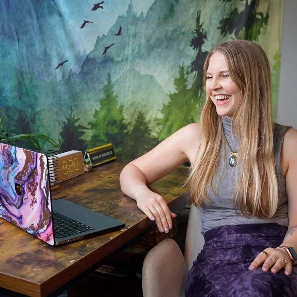 Valerie Martin Therapist in Nashville looking at a computer smiling during a virtual therapy session