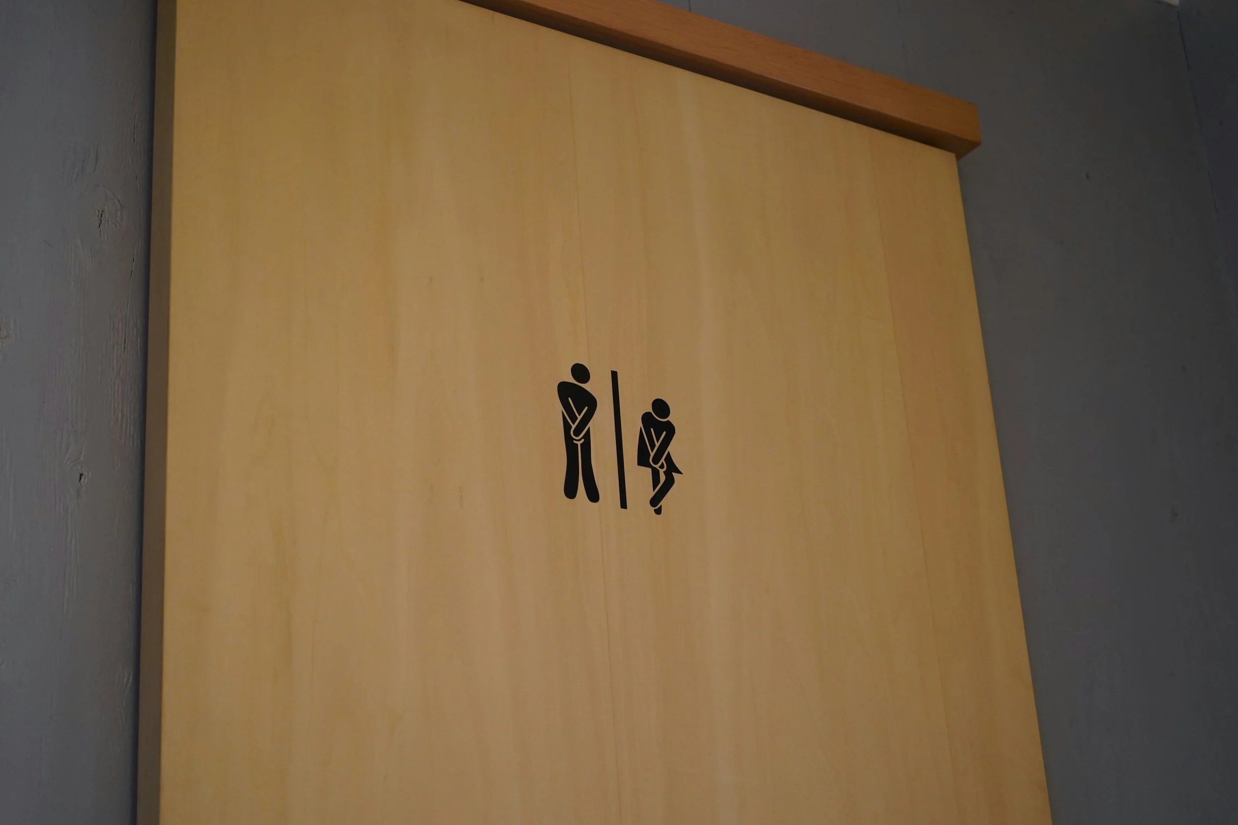 bathroom sign with gotta go right now poses
