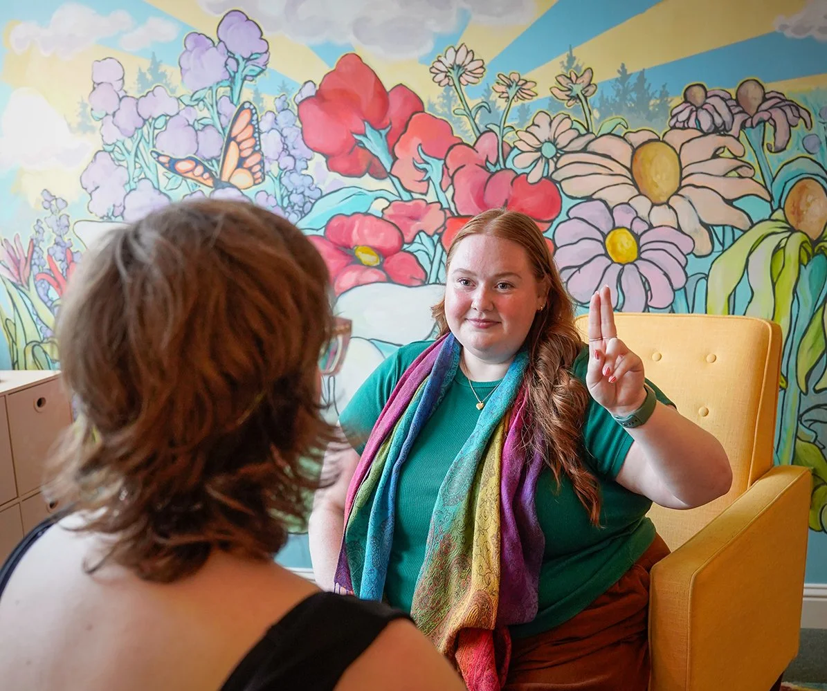 EMDR Therapist in Nashville working with a client in front of a colorful background