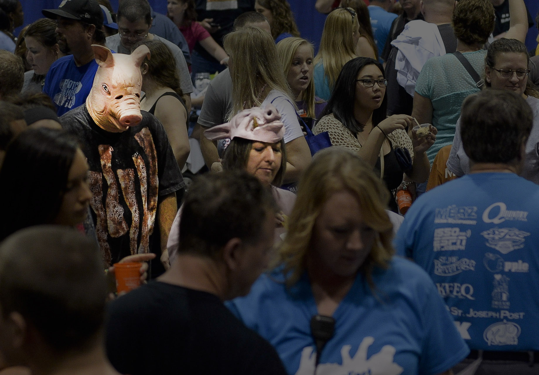   A man wearing a pig mask and a shirt with bacon strips walks through a crowd at the 1st annual BaconFest in St. Joe, Mo on Saturday, Sept. 27, 2014.&nbsp;Over 1,300 people showed up to the event. All the proceeds went to the Dream Factory, an organ