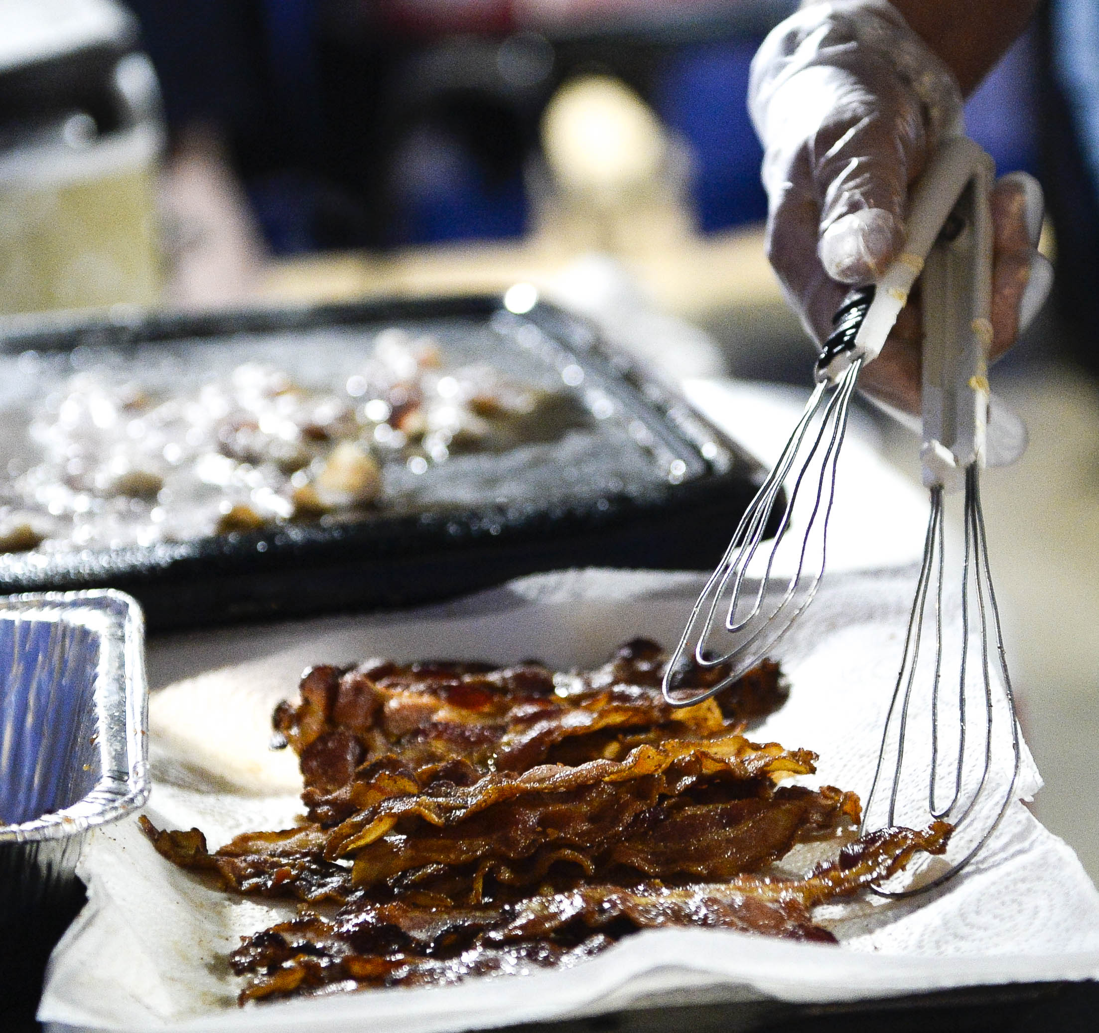  Susie McCreary, 76, owner of the St. Joe Harley Davidson fries bacon while preparing a jalapeno balmers recipe her employee, Jackie Kalinka, 28, came up with for the recipe contest. “She's our designated bacon cooker today because it’s the most imp